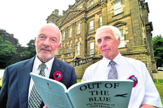 Jim Mackay (L) and Ian Williams with the book they wrote.