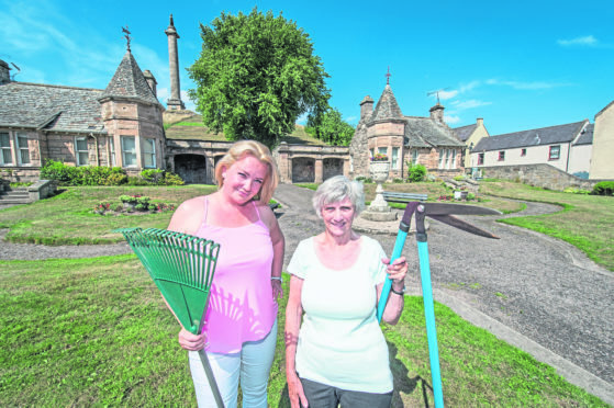 Councillor Maria Mclean (left) and Volunteer Gardener Anne Glover (right) pictured in front of Sulva Cottage at the bottom of Lady Hill, Elgin, Moray.