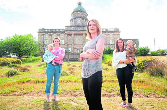 Keep Mum campaigners Amy Allen, Kirsty Watson and Sarah Medcraf stand in front of Dr Gray’s Hospital in Elgin