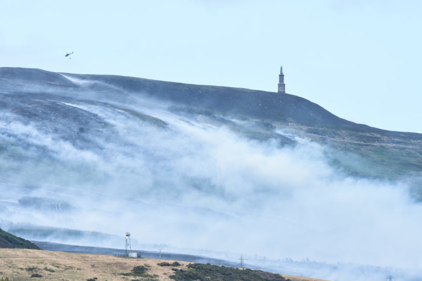 Picture by JASON HEDGES 

Pictures show large areas of smoke and fire crews fighting a gorse fire at Ben Bhraggie, near the Duke of Sutherland Statue.