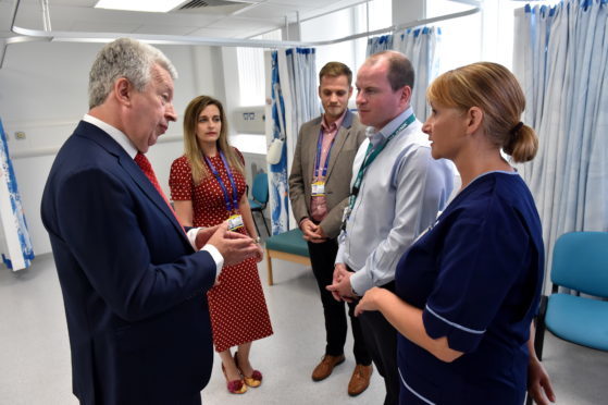 Picture of Lewis Macdonald meeting staff (L-R) Gillian Poskitt, Alan Cooper, Dr Paul Bourke and Karen Richardson.