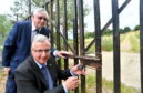 Councillors Dominic Lonchay and Fergus Hood at the entrance gate to the walk over Tuach Hill which will be opened again soon after an asbestos problem was resolved.