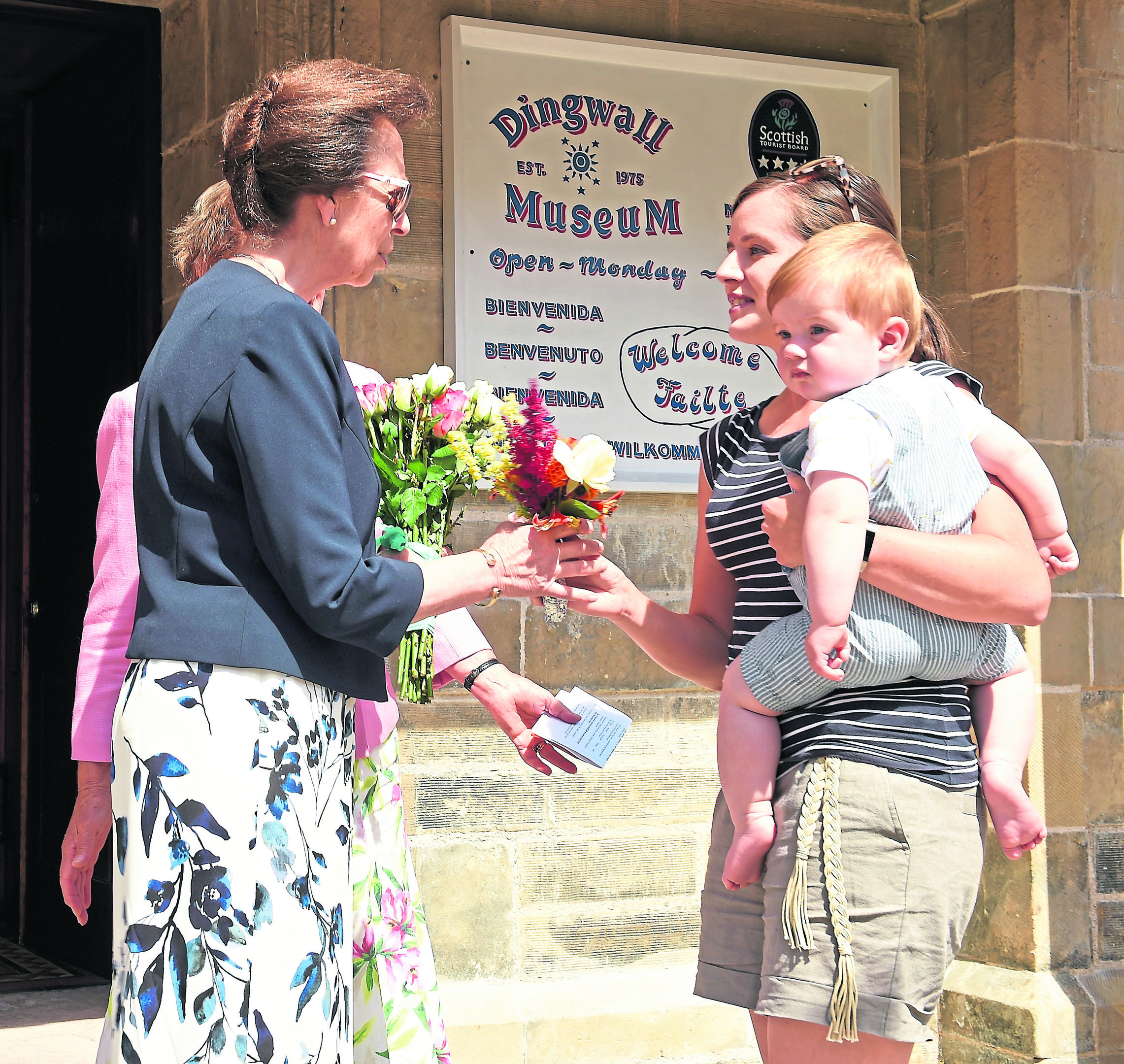 HRH The Princess Royal, Princess Anne yesterday visited Dingwall where she undertook two engagements. Anne Ross of Dingwall accompanied by her son Struan (11mths) present a bouguet of flowers to the Princess after Anne made a similair presentation to the princess as a two year old outside Dingwall Town Hall twenty eight years ago.
Picture by Sandy McCook.