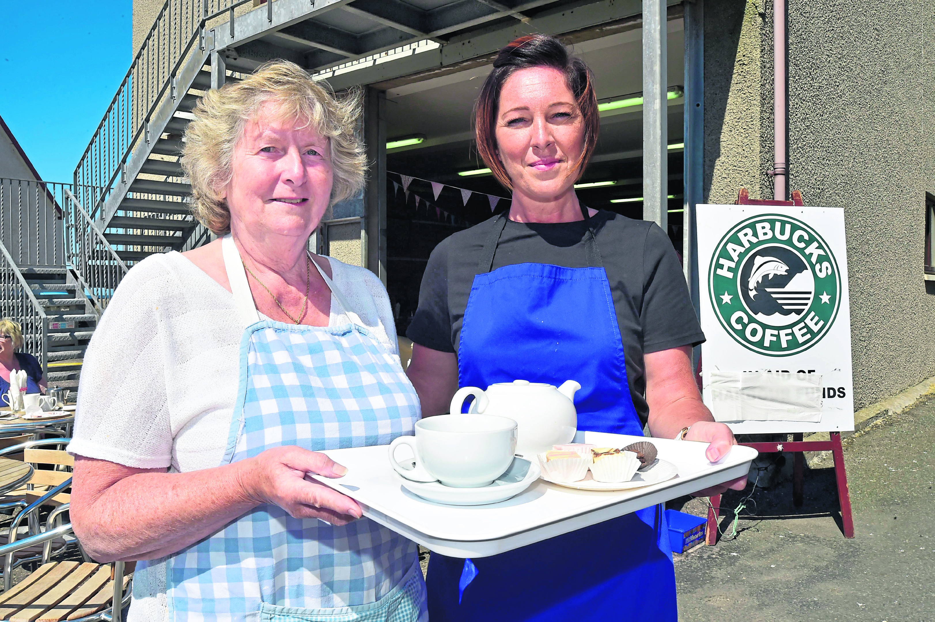 Volunteer Betty Jack, left, with support worker Ashley Runcie ready to serve customers at the cafe.