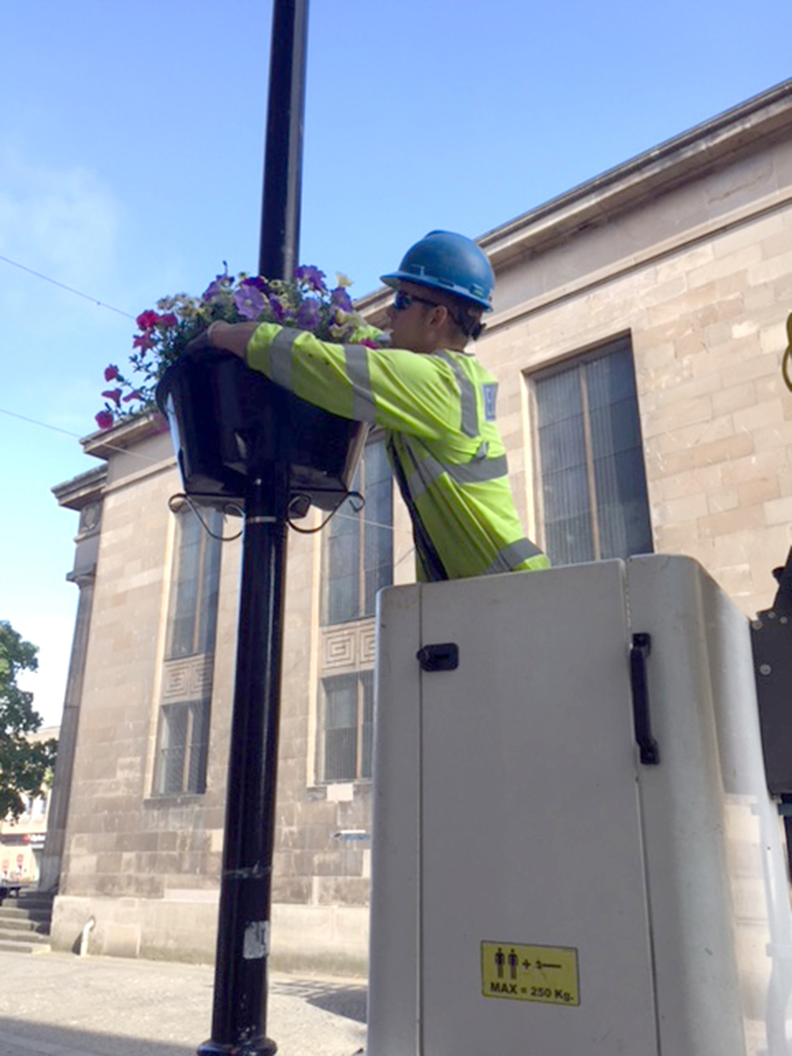 Teams from SSEN helped put up the flower baskets in Elgin town centre.