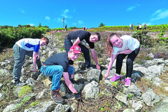 Mintlaw Academy pupils (L-R) Colby O'Hara, Henry Arnott, Liam Taylor and Rachel Burnett clearing the stag on Mormond Hill.