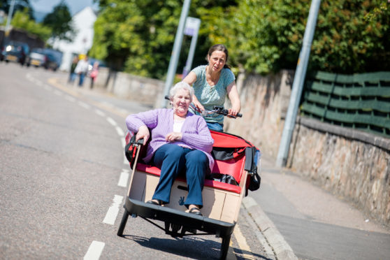 Dr Katie Walter takes Mary Dyce for a ride at the WheelNess to Wellness project, Inverness Launch.