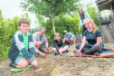 Children and adults alike volunteer to help tidy up the garden at Moray Arts Centre, Findhorn.

Picture by Jason Hedges.