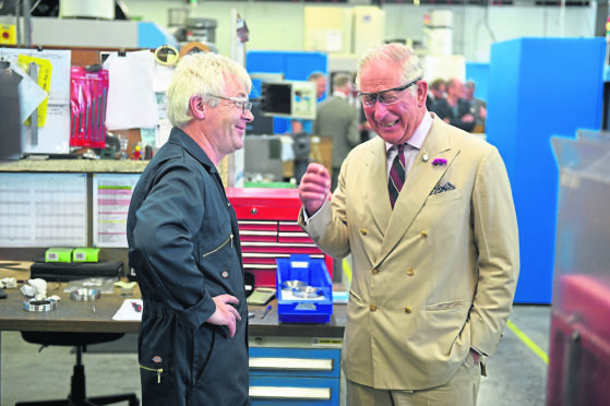 The Duke of Rothesay with Machine Technician Harry Coghill at Kongsberg Maritime, Wick. 
Picture by Sandy McCook.