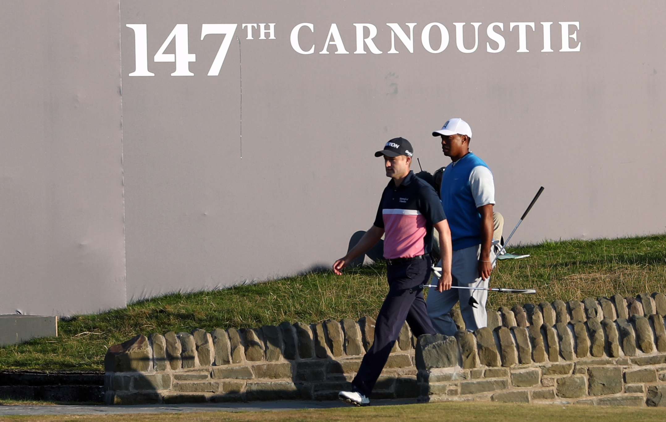 Russell Knox and Tiger Woods walk onto the 18th during day one of The Open at Carnoustie.