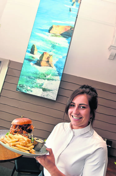 Supervisor Leanne Hampton with The Dirty Spaniard burger.