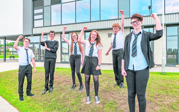 L-R - Angus Little, Stewart Ewen,, Emily Sutherland,, Eilidh Stewart, Andrew McIntyre and Morgan McRitchie at Elgin High School all jumping for joy at passing their exams.