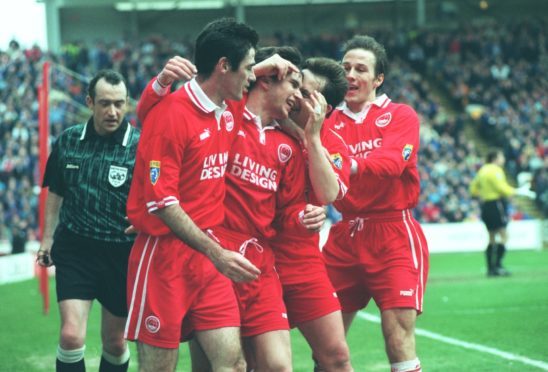 Stephen Glass is congratulated by Mike Newell, Billy Dodds and Eoin Jess after scoring against Rangers in 1998.