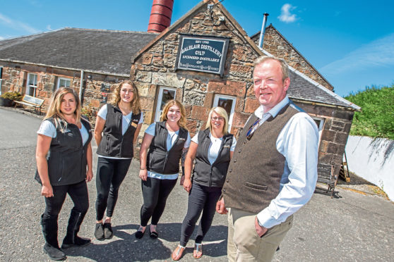 John MacDonald, manager at Balblair, with staff at the popular at the popular distillery