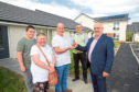 Calum Macaulay, of Albyn Housing, hands over the keys of their new house to Gordon and Charlotte Maclennan and their son Gordon, with Gavin Brown of Compass Construction.