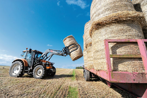 Picture by SANDY McCOOK  29th September '17
Following a very wet harvest, Alan Mathieson of Ardgay collects straw bales from Fearn in Easter Ross.