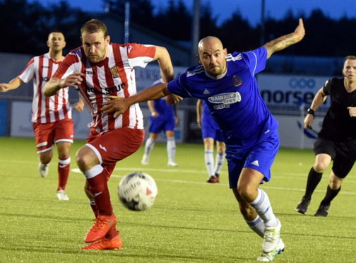 Garry Wood and Paul McManus tussle during the Cove Rangers v Formartine United tie.