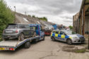 Police at the scene  of a major investigation after stolen cars and drugs were recovered from a farm.