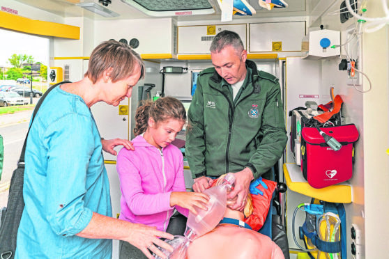 Julie and Sarah Wallace are given a demonstration by paramedic Tony Reid.