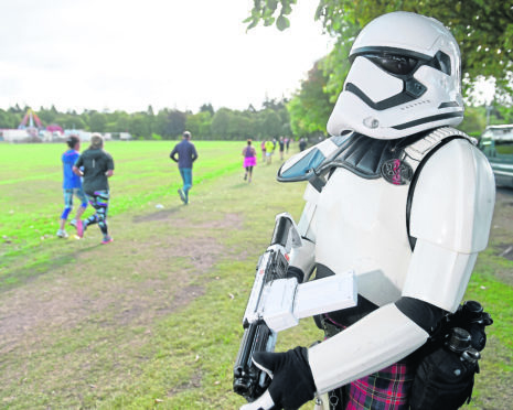 Stormtrooper Dan Gillespie of Aberdeen keeps an eye on park runners close to the Inverness Ice Arena.