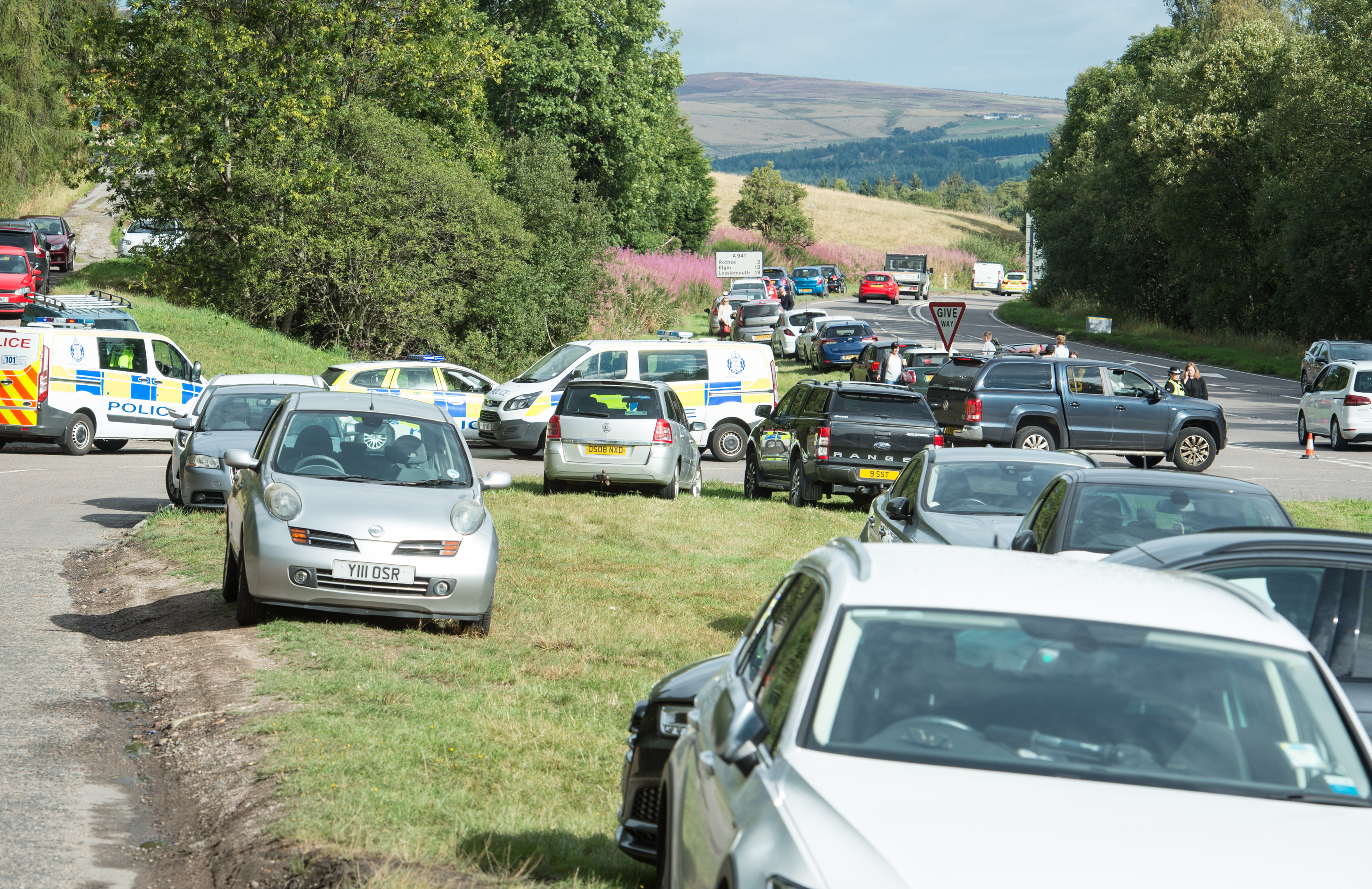 Cars park on the A941 Elgin road near Craigellachie in an attempt to reach the Macallan distillery.