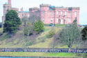 Runners make their way past Inverness Castle.