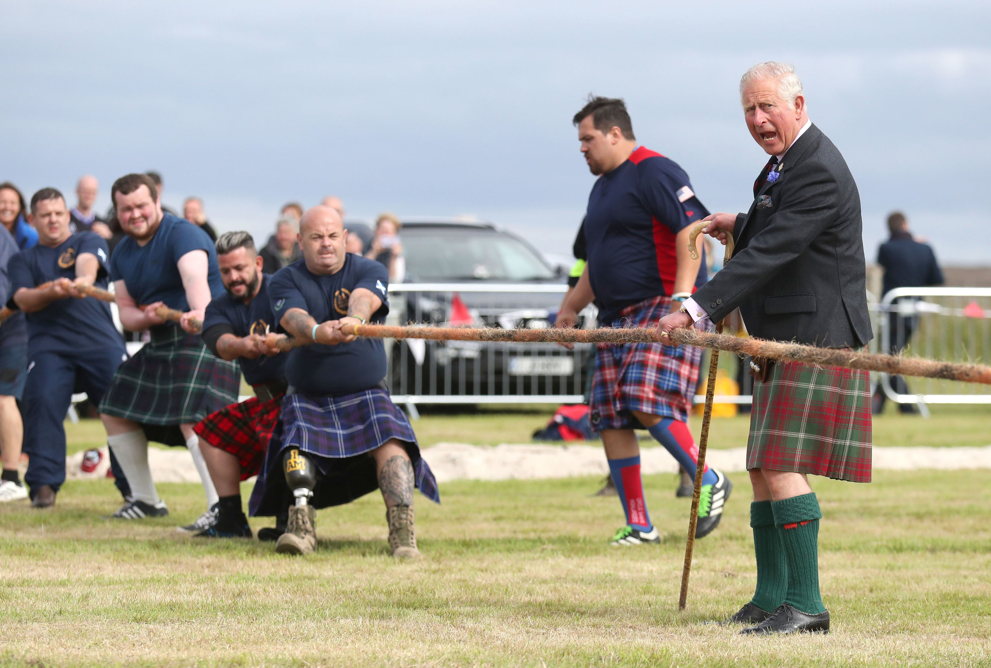 The Duke of Rothesay judging a tug-of-war competition.