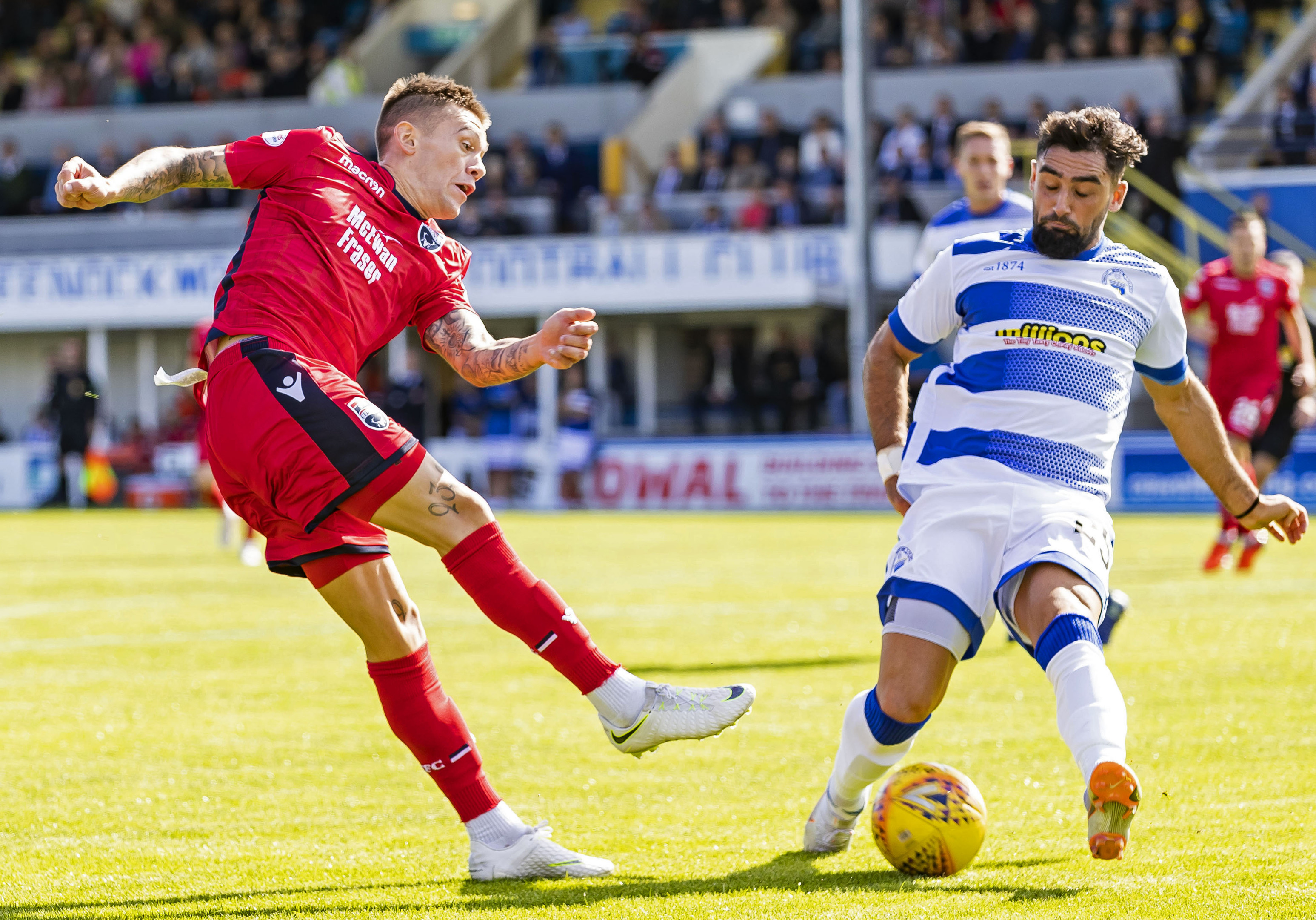 Ross County's Josh Mullin is challenged by Morton's Rory McKeown.