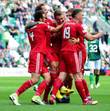 Tommie Hoban is congratulated after bagging his first goal for Aberdeen.