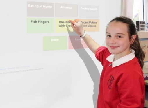 Grace Rennie, P6 pupil at West End Primary School, places her lunch order.