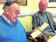 Author Graham Johnston (R) and Charles Lindsay Abernethy with the original diary his father carried in the trenches.