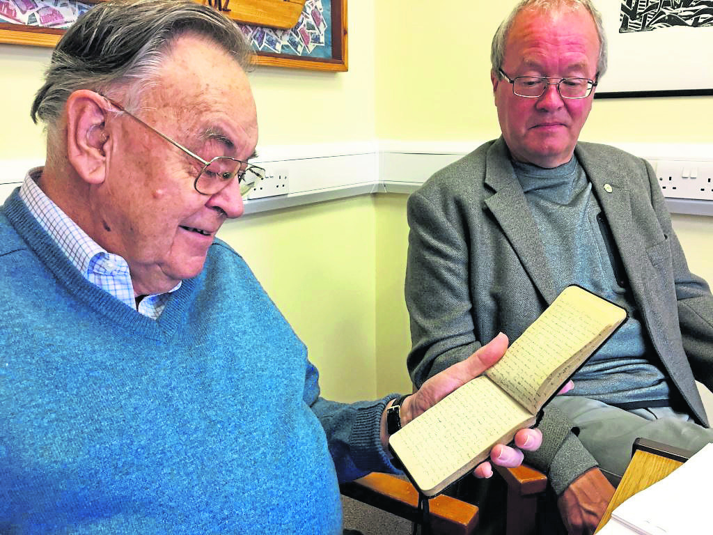 Author Graham Johnston (R) and Charles Lindsay Abernethy with the original diary his father carried in the trenches.