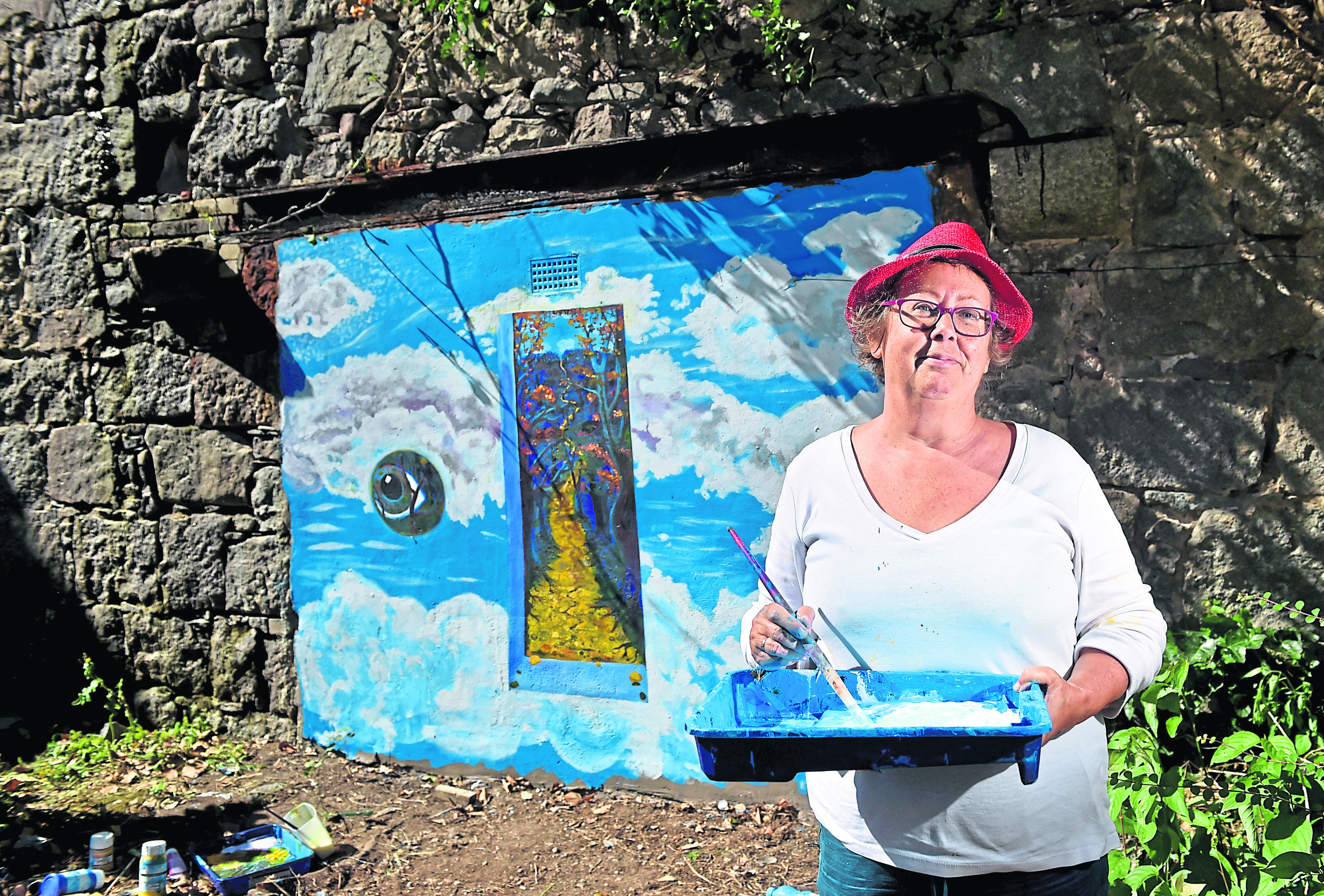Alison Chandler, a cancer survivor, is finishing her art installation today that depicts the importance of bravery through her treatment on South College Street