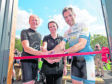 Mark Beaumont (right) cuts the ribbon to open the cafe with Kenneth and Lesley McKenzie.