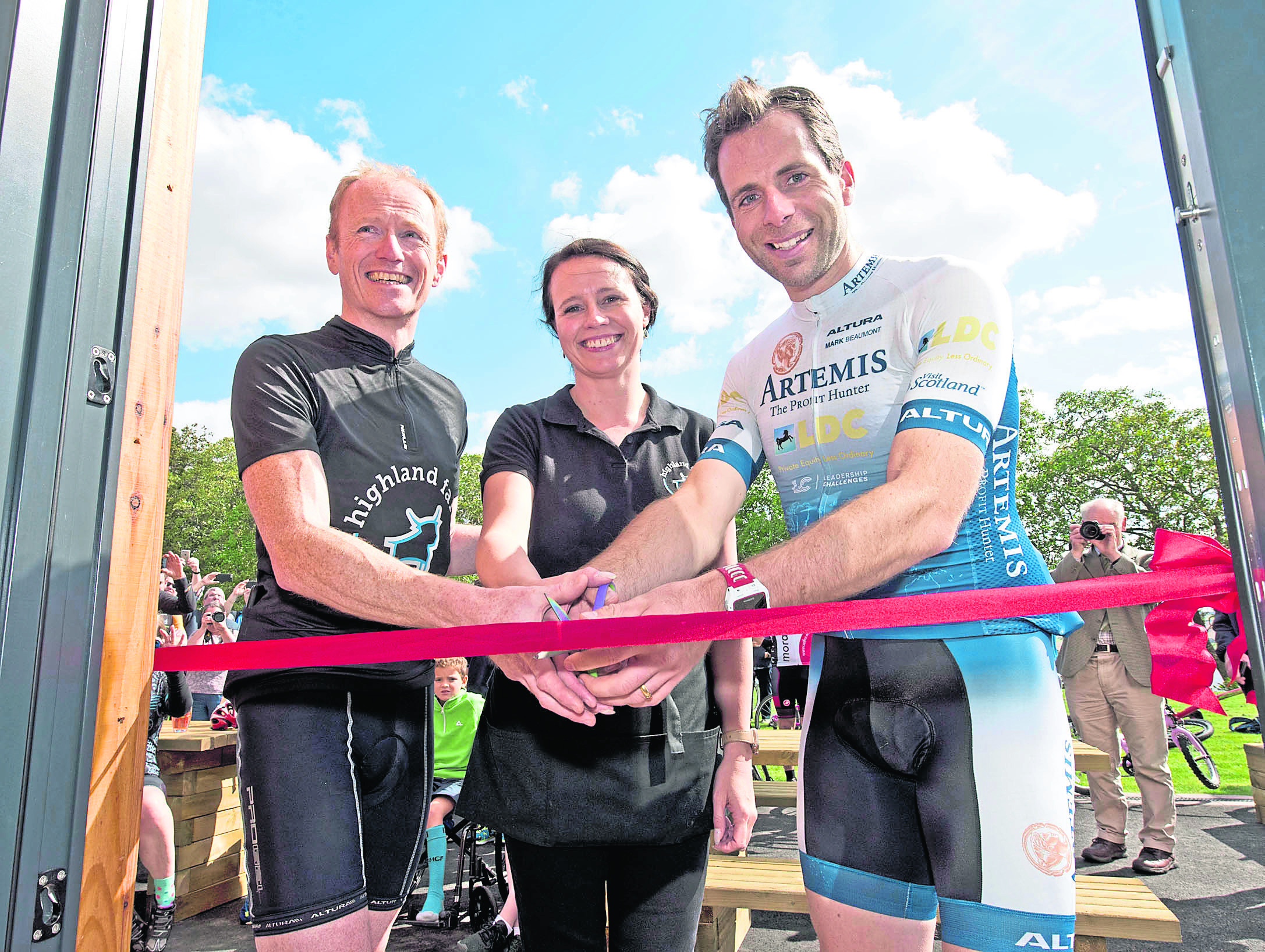 Mark Beaumont (right) cuts the ribbon to open the cafe with Kenneth and Lesley McKenzie.