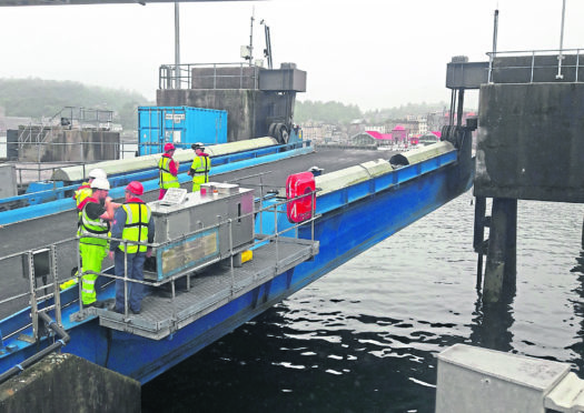 Workers inspect the Oban linkspan.