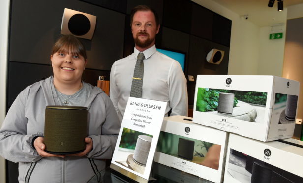 Aimi Forsyth receives her prize from Aberdeen Bang & Olufsen store manager Ryan Hughes.