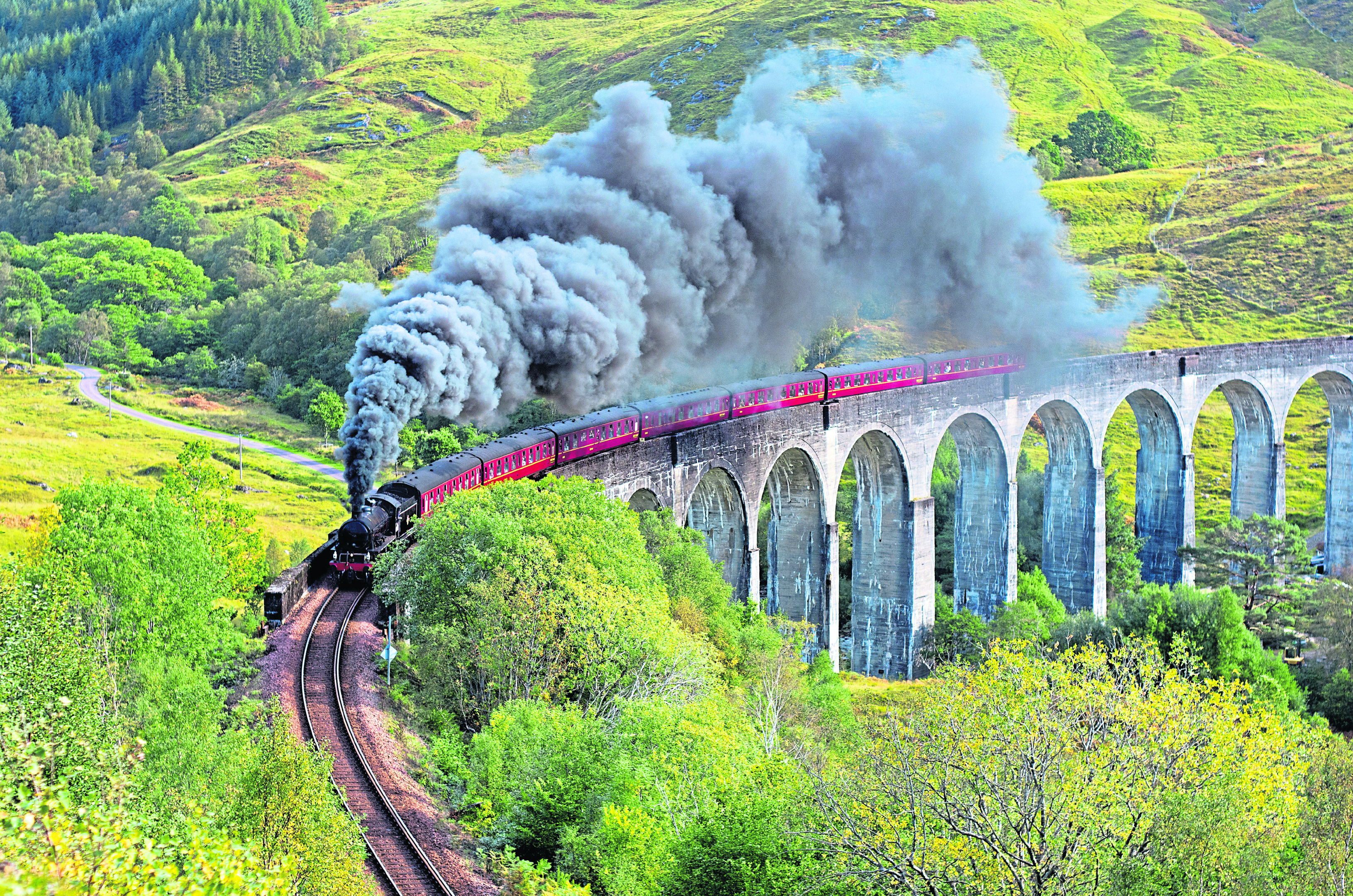 Steam train crossing the Glenfinnan Viaduct in Scotland.
