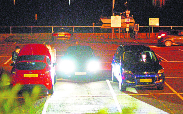 Cars gather in Fort Williams West End Car park.