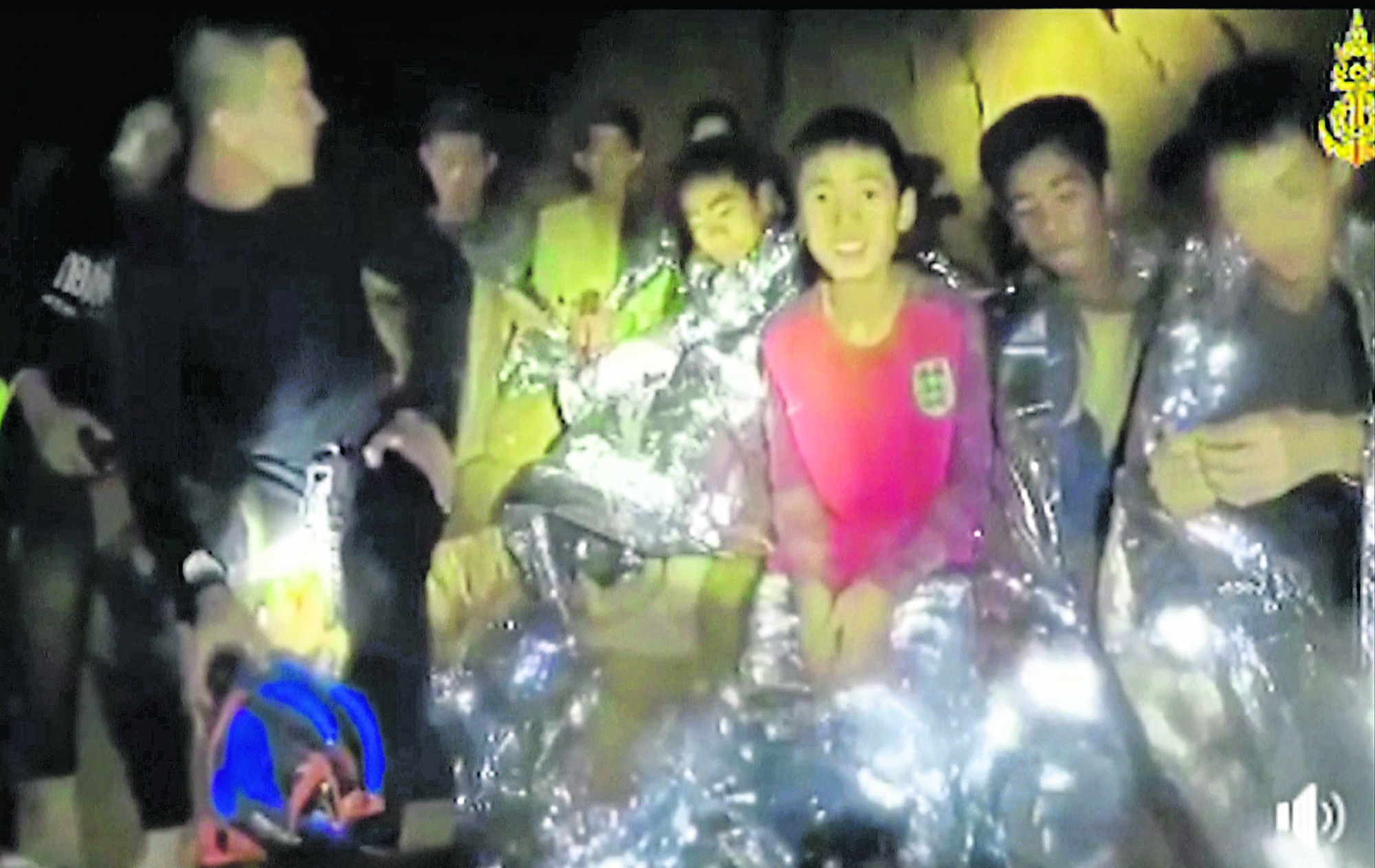 In this July 3, 2018, image taken from video provided by the Thai Navy Seal, Thai boys are with Navy SEALs inside the cave, Mae Sai, northern Thailand.