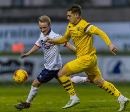 Forres Mechanics midfielder Alan Pollock (right).