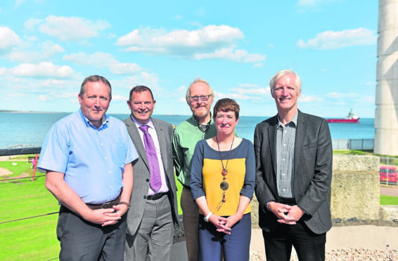 The five original members of Aberdeen Renewable Energy Group, seen recently at Aberdeen beach, are David Roger, John Black, Jeremy Cresswell, Morag McCorkindale, and Iain Todd.