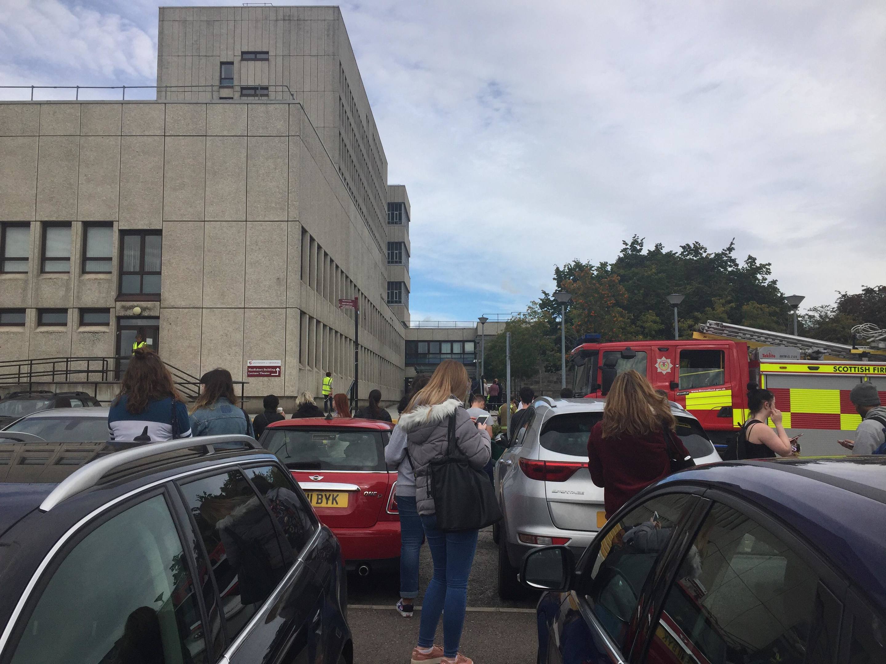 Students waiting outside Aberdeen University's MacRobert building following an evacuation on discovery of a bin fire.
Photo: Joanne Warnock