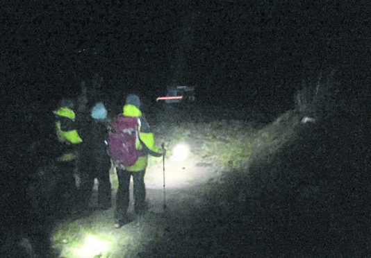 A small team of CMRT guiding the pair of lost walkers off the Cairngorm plateau.