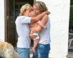 Ellie's mother delivering kisses and cuddles to her grandson