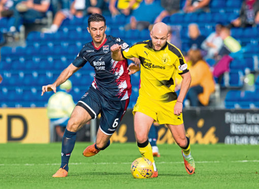 Ross County's Ross Draper (L) in action with Raith Rovers' Grant Gillespie.