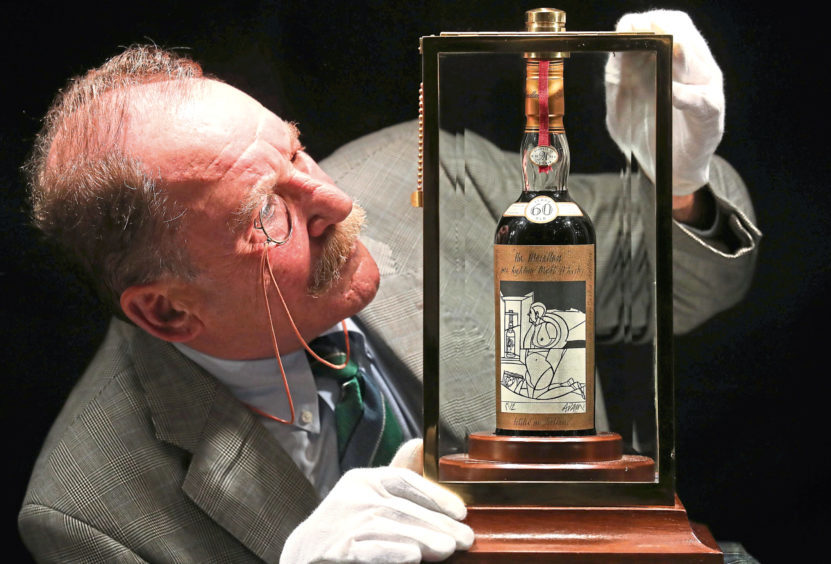 Whisky expert Charles MacLean with the worlds rarest and most valuable whisky