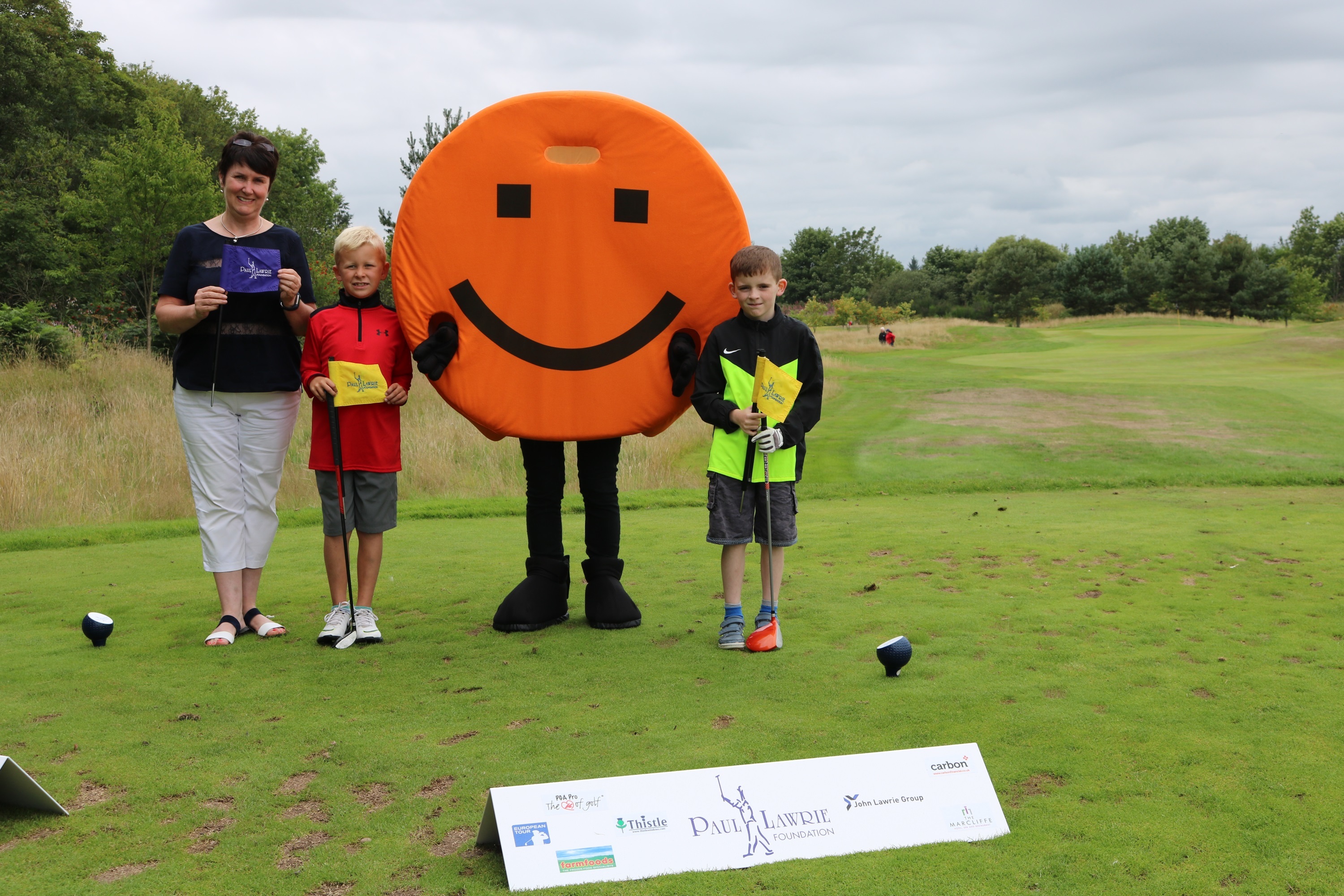 Sheena Anderson of AABi with Fletcher Riach and Riley Reid taking part in the Grass Roots golf programme at The Paul Lawrie Foundation.
