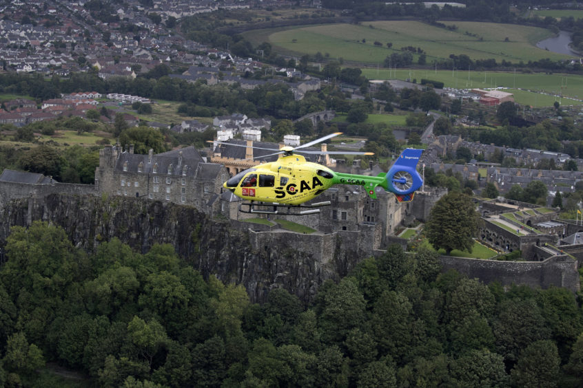 ‘Helimed 76’ is pictured flying over Stirling Castle
