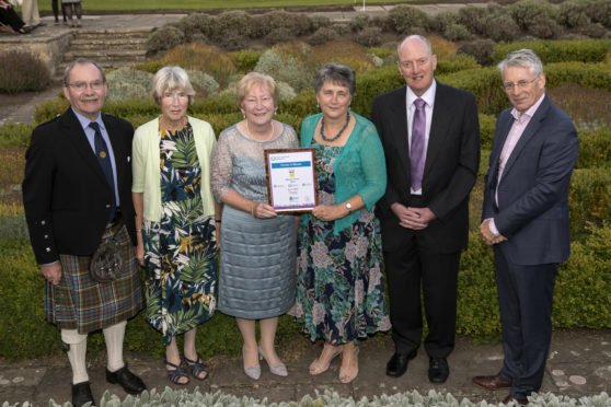 Forres in Bloom volunteers receive their award.